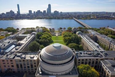 Aerial photo of the MIT dome and Killian Court facing the Charles River and Boston.