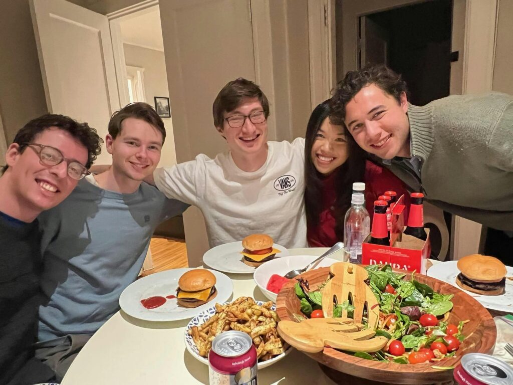 Friends pose with Minh-Thi around table