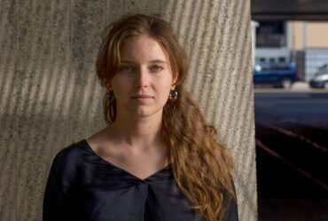 Dominika Ďurovčíková stands outside with MIT buildings in background.